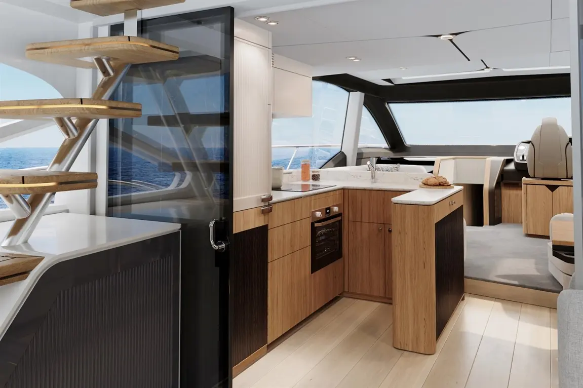 Modern boat interior featuring a stylish kitchen with wooden cabinetry and sea views through large windows.